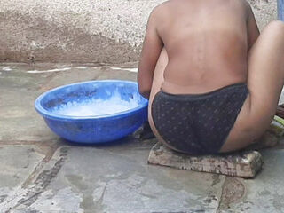 My relative's housewife is taking bath in the open bathroom wearing black underwear at my house