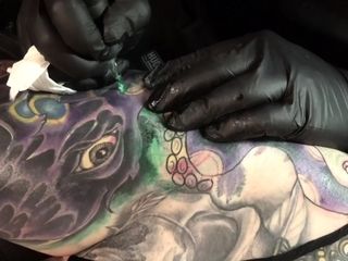 Marie Bossette gets a painful tattoo on her leg